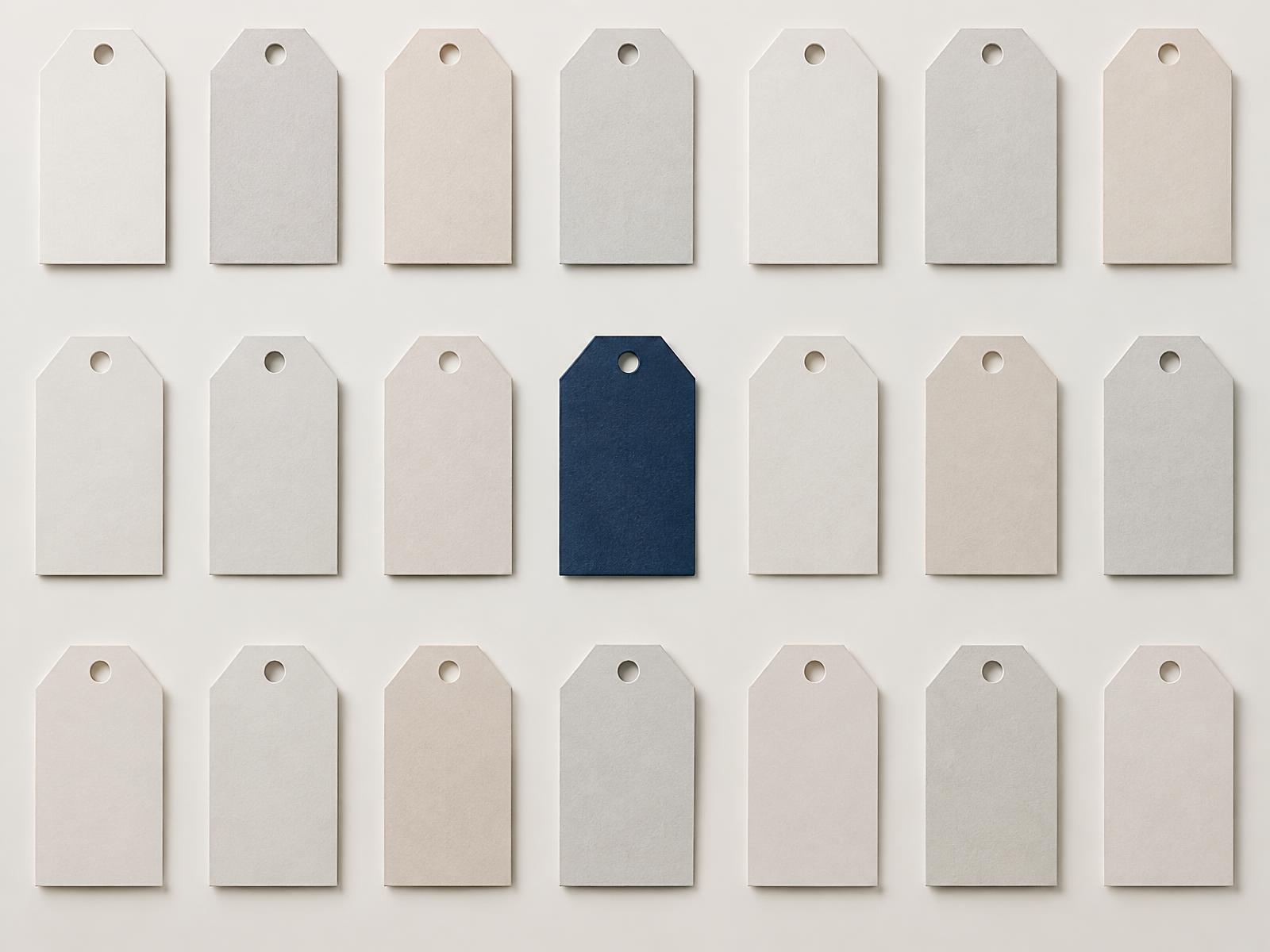 Rows of aligned price tags with one deep blue tag standing out